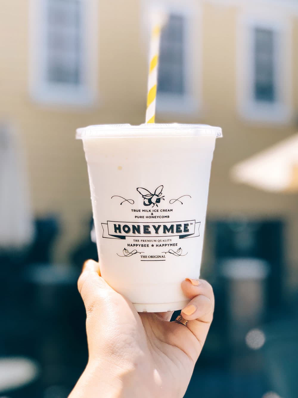 Honeymee milkshake held up in front of the shop